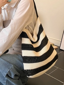 Minimalist black and white striped knit tote bag featuring a crochet hollow-out design