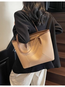 Large camel pebble leather tote bag for women shown worn on shoulder with black blazer