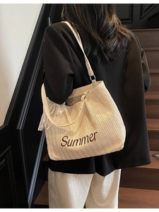 Woven straw summer tote bag in beige with brown embroidery and pearl lace charm detail