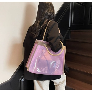 Detail of purple transparent tote with rope handles and interior accessory book
