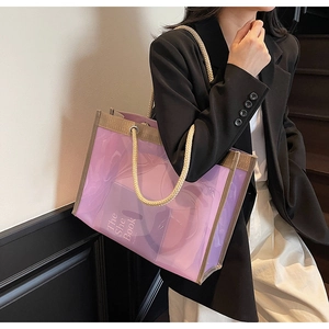 Detail of purple transparent tote bag with thick rope handles and reinforced brown trim