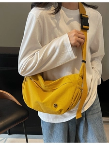 Lightweight bright yellow nylon crossbody crescent bag with adjustable wide shoulder strap