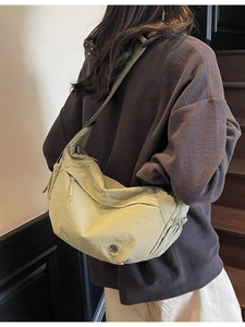 Minimalist olive green nylon crossbody bag with adjustable wide strap and metal logo