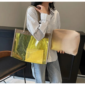 Detailed view of yellow transparent PVC tote bag with rope handles and inner pouch