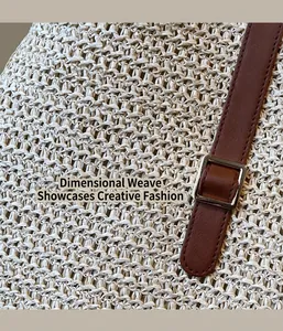 Close-up of woven straw texture with brown leather strap and silver metal buckle