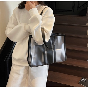 Détail du grand sac cabas en PVC transparent avec rayures noires et intérieur vaste