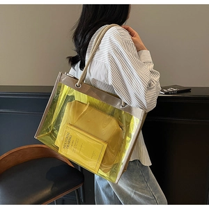 Detail view of transparent yellow PVC tote bag with leather pouch and rope handles