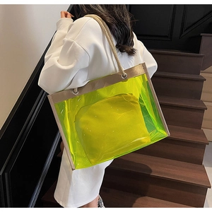 Detail of neon yellow transparent PVC tote bag with woven rope handles and inner pouch