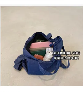 Top view of blue denim tote bag interior showing space for tablet, notebook and umbrella