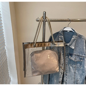 Detailed close-up of clear PVC tote with a woven rope handle and khaki inner pouch
