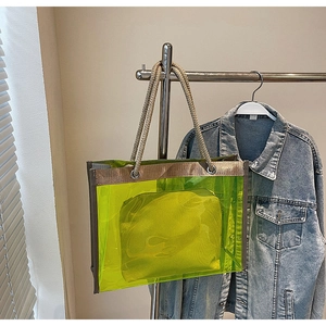 Neon green transparent PVC tote bag with thick woven rope handles and inner pouch