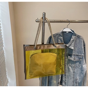 Detail of yellow transparent PVC tote bag with thick cotton rope handles and inner pouch