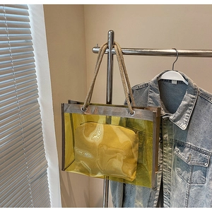 Detail of yellow transparent PVC tote with inner pouch and rustic rope handles