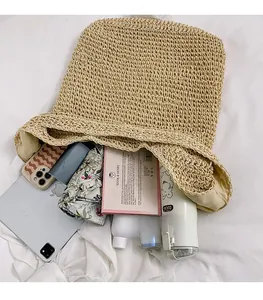 Top view showing spacious interior of the woven straw tote bag with daily essentials