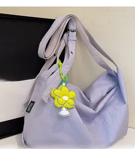 Detail of lavender canvas tote bag featuring adjustable wide strap and yellow daisy charm