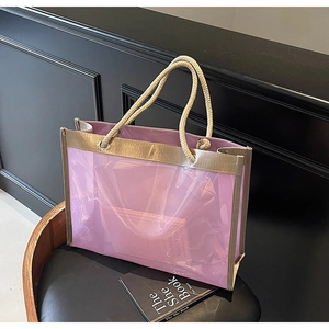 Detail of purple transparent PVC tote bag with gold trim and sturdy rope handles on a chair