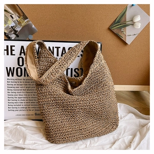 Close-up of woven straw tote bag with fabric lining and metal magnetic closure