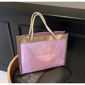 Detail of purple transparent tote bag with woven rope handles and a pink inner pouch