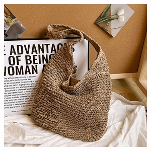 Detailed view of woven straw tote bag with fabric lining and secure magnetic metal closure