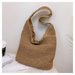 Detailed view of handmade khaki woven straw tote bag with fabric lining and magnetic closure