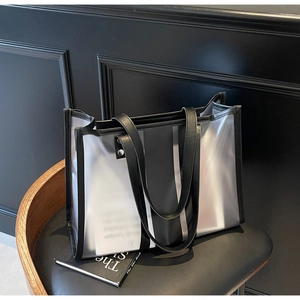 Detail of transparent PVC tote bag featuring black matte splicing and elegant shoulder straps