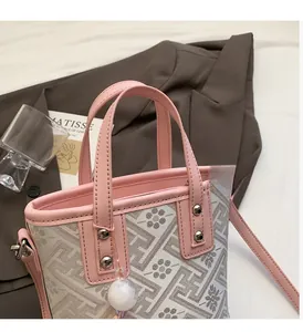 Detail of pink leather trim and floral jacquard pattern on a stylish bucket bag