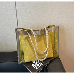 Detail of yellow transparent PVC tote bag with rope handles and fabric inner pouch