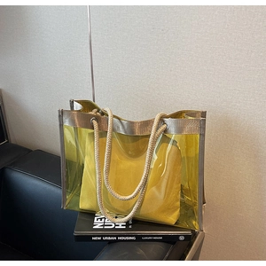 Detail of yellow transparent PVC tote bag with inner pouch and white cotton rope handles