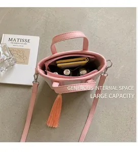 Top view of pink leather bucket bag interior showing spacious storage and inner pocket