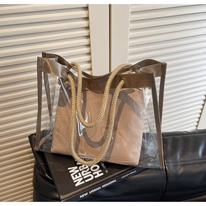 Detail of transparent PVC tote bag with canvas insert and rustic rope handles