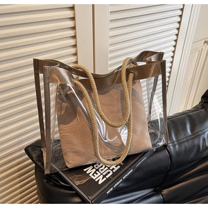 Detail of transparent PVC tote bag with beige fabric insert and thick hemp rope handle