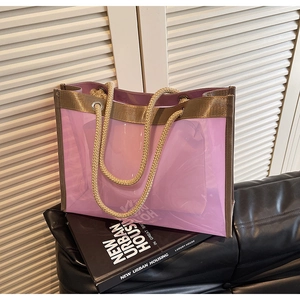 Close-up of semi-transparent PVC tote bag with rope handles and matching inner pouch