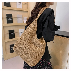 Detail of hand-woven straw tote bag with shoulder strap and large capacity