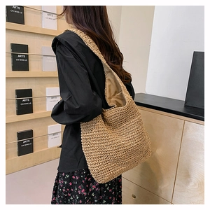 Detail view of large straw tote bag with handwoven texture for summer commute