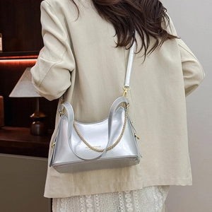 Detail of silver glossy crossbody bucket bag with chain strap and fashion bags text