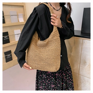 Detailed texture of large straw tote bag featuring handcrafted woven patterns for women