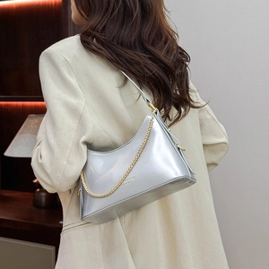 Detail of silver metallic bucket bag with golden chain and fashion leather texture