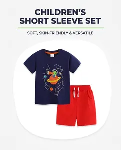 Detail of navy boy's t-shirt with alien print and red shorts set on white background