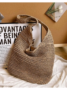 Large khaki hand-woven straw hobo bag for women with wide shoulder strap and magnetic closure