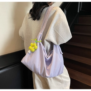Crescent purple shoulder bag with pleated texture and yellow flower charm decoration