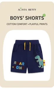 Close-up of navy cotton boys' shorts featuring dinosaur embroidery and yellow drawstring