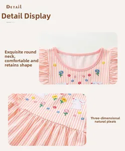 Close-up of pink striped dress with rabbit flower embroidery and pleated skirt details