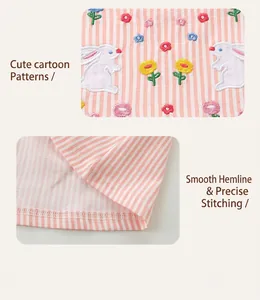 Detail of pink striped dress with exquisite rabbit and floral embroidery on fine fabric