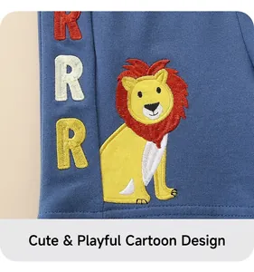 Detailed close-up of cartoon lion embroidery and 'RRR' letters on blue cotton boy shorts