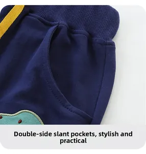 Detail of kids navy shorts showing elastic waistband with yellow drawstring and side pockets