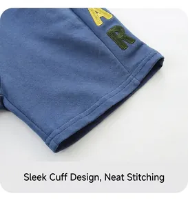 Detail of navy boy shorts showing neat stitching and vintage lion embroidery patch