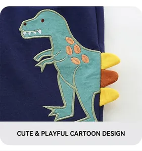 Detail of embroidered green dinosaur patch on navy blue cotton children shorts