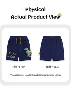 Detailed close-up of kids navy cotton shorts with green dinosaur and Roar-some embroidery