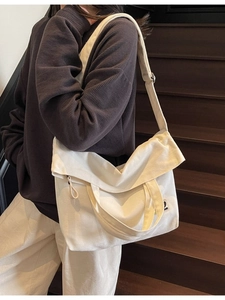 Vintage style cream canvas tote bag with shoulder strap and embroidery detail