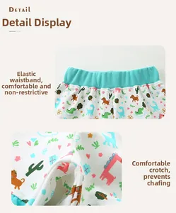 Detail of girls' cotton shorts with elastic waistband and dinosaur animal print